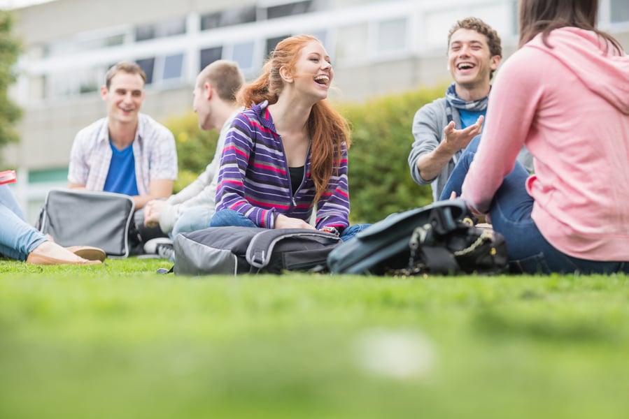 Group of young college students sitting in the park