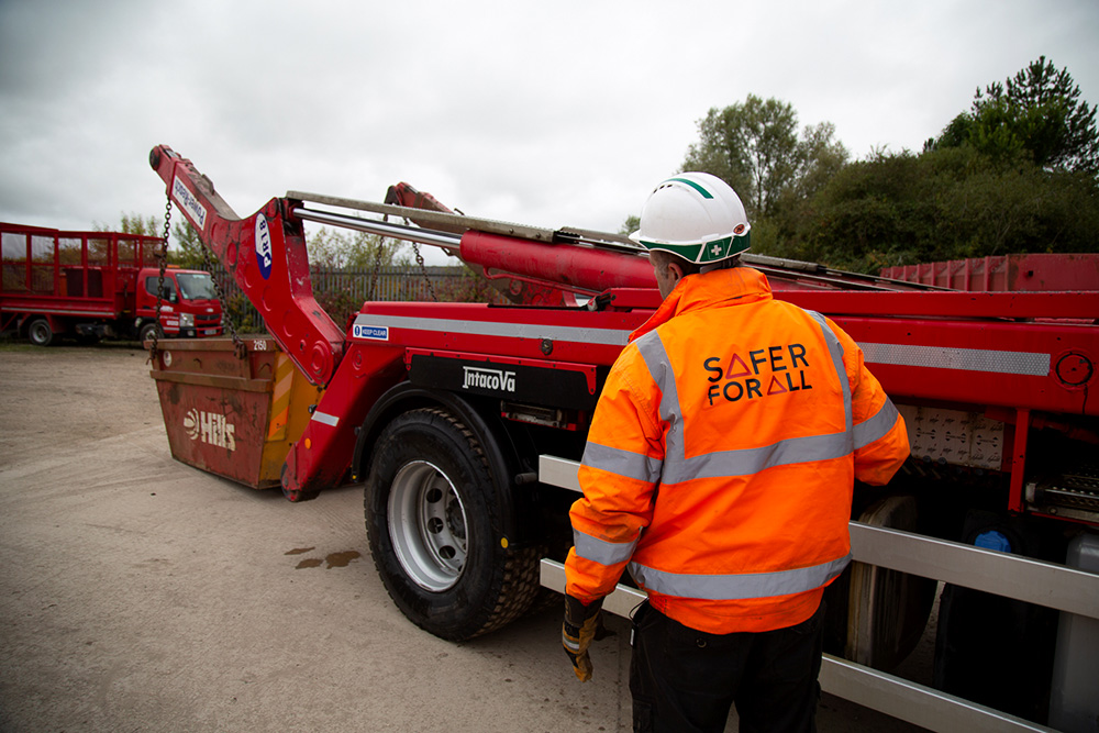 worker-in-ppe-by-skip-lorry